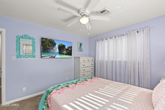 tiled bedroom featuring baseboards, ceiling fan, and visible vents
