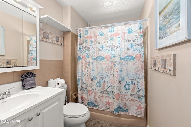 bathroom featuring vanity, toilet, tile walls, tile patterned floors, and shower / bath combo