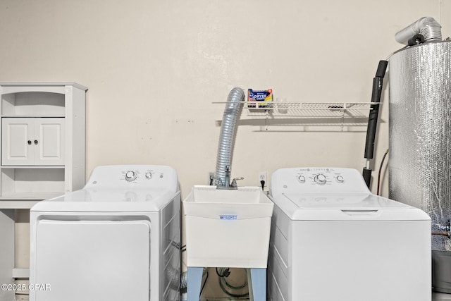 laundry room with laundry area, a sink, and independent washer and dryer