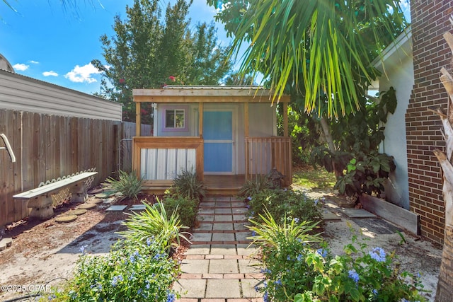 exterior space with fence and an outbuilding