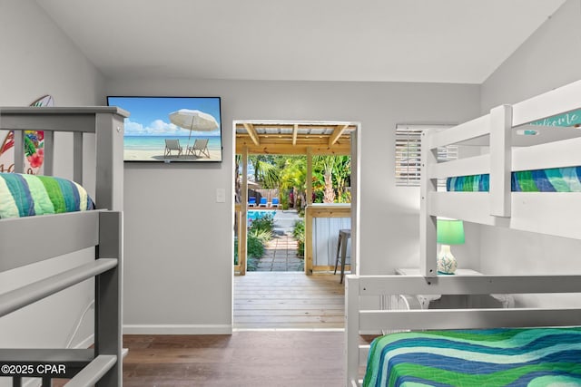 bedroom with baseboards and wood finished floors