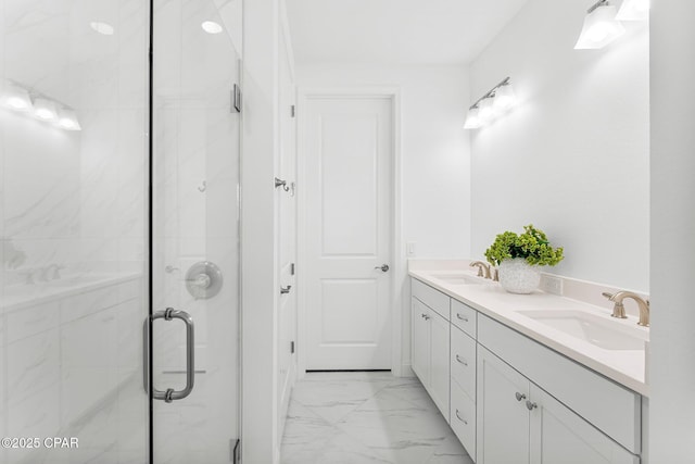 full bathroom featuring double vanity, a sink, marble finish floor, and a shower stall