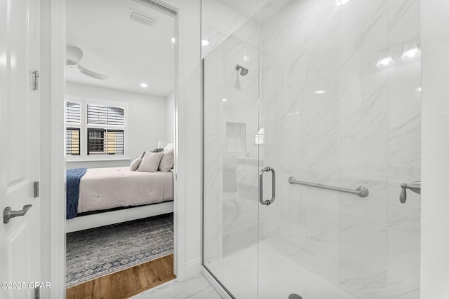 ensuite bathroom with visible vents, marble finish floor, connected bathroom, and a stall shower