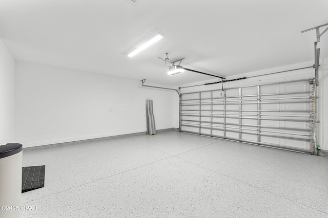 garage featuring baseboards and a garage door opener