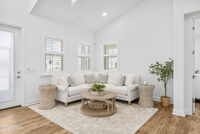 living room with recessed lighting, baseboards, vaulted ceiling, and wood finished floors