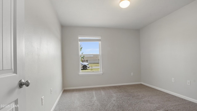 carpeted spare room with baseboards
