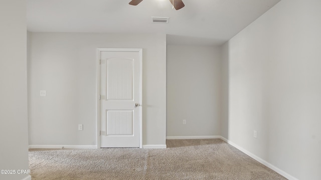 spare room featuring visible vents, a ceiling fan, baseboards, and carpet floors