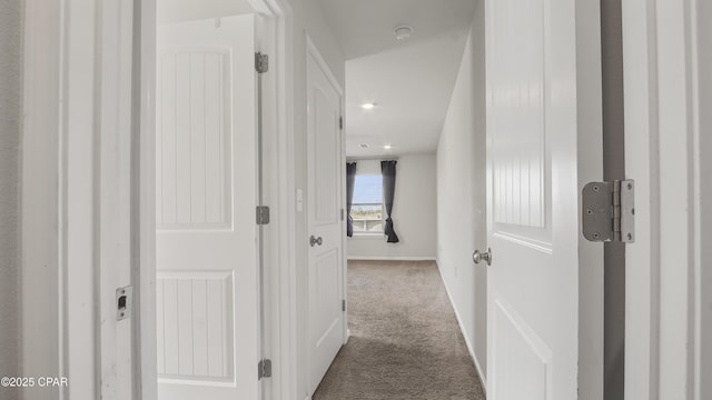 corridor featuring baseboards, recessed lighting, and carpet