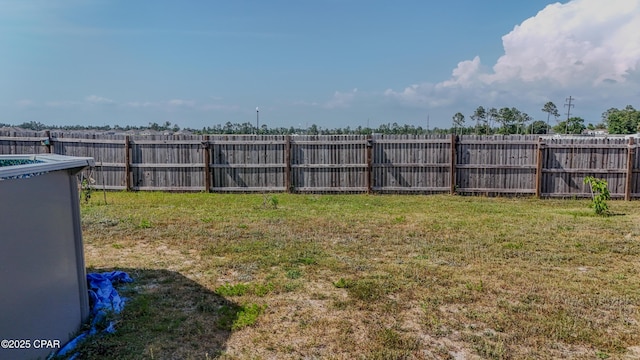 view of yard with a fenced backyard