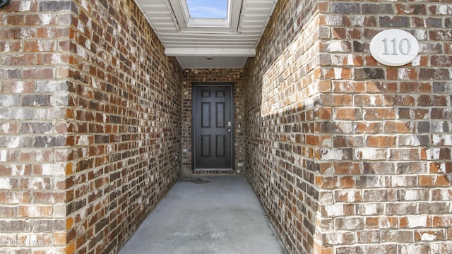 property entrance with brick siding