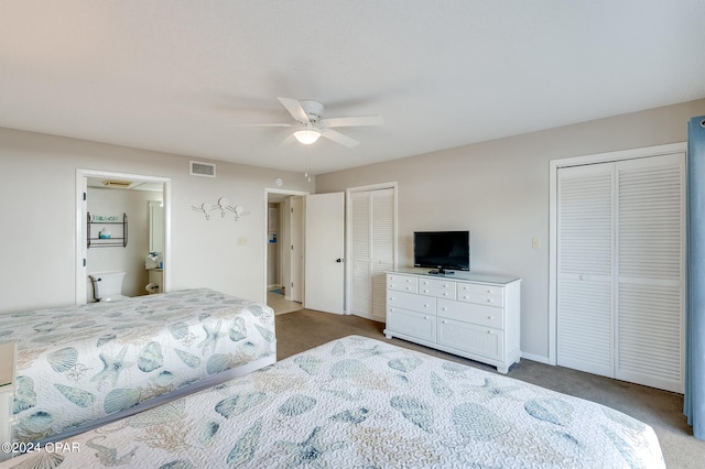 bedroom with multiple closets, carpet flooring, baseboards, visible vents, and a ceiling fan
