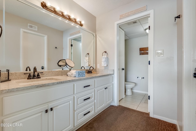 bathroom featuring visible vents, toilet, and a sink