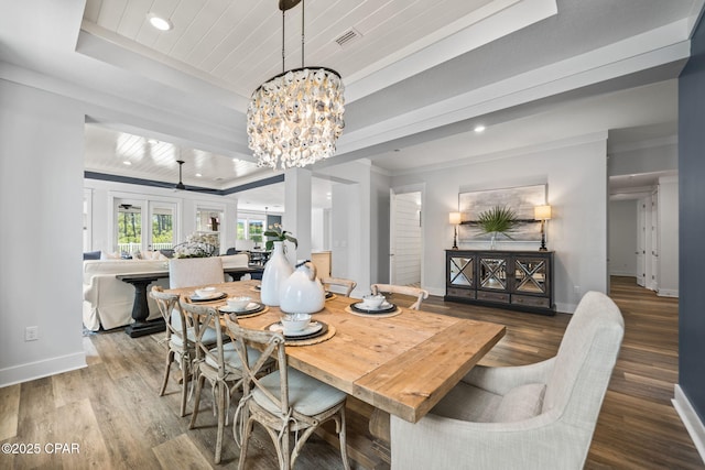 dining room with wood finished floors, recessed lighting, a notable chandelier, and baseboards