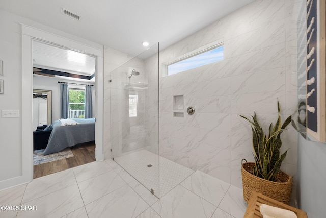 full bath with a walk in shower, visible vents, and ensuite bathroom