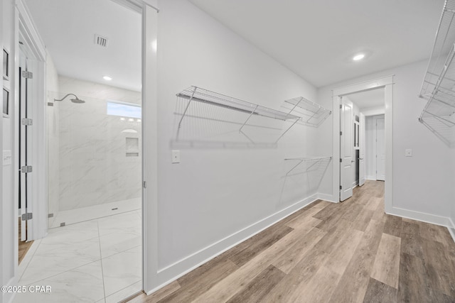walk in closet featuring visible vents and light wood finished floors