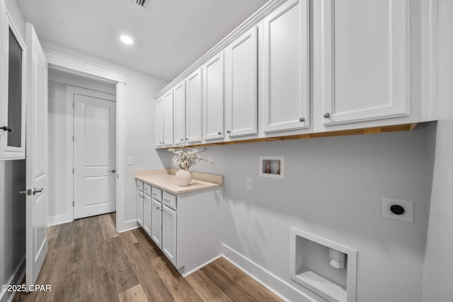 laundry area featuring baseboards, dark wood-style floors, cabinet space, and hookup for an electric dryer