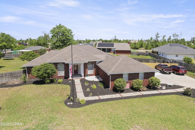 924 N College Blvd, Lynn Haven, FL 32444 - view of front of house featuring roof with shingles, a front yard, brick siding, and a fenced backyard