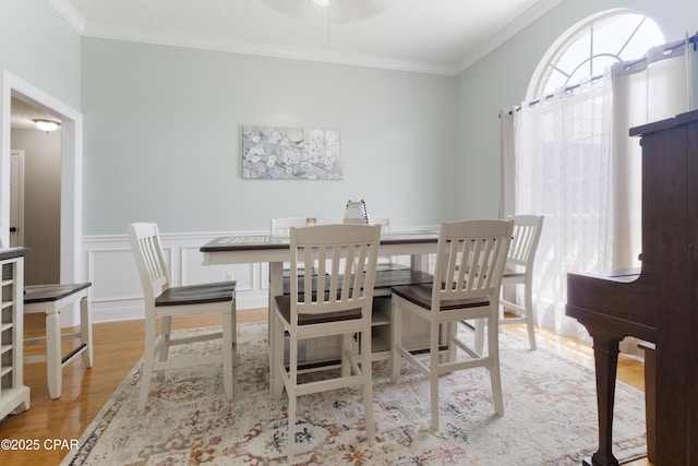 924 N College Blvd, Lynn Haven, FL 32444 - dining space featuring a wainscoted wall, wood finished floors, a ceiling fan, and ornamental molding