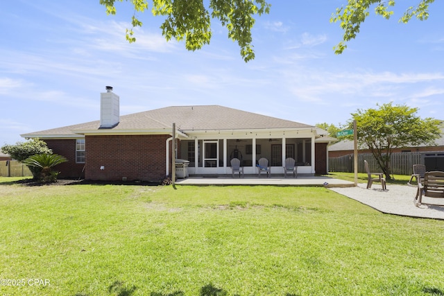 924 N College Blvd, Lynn Haven, FL 32444 - rear view of property with a patio, fence, a sunroom, and a lawn