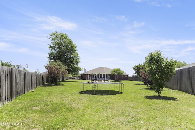 924 N College Blvd, Lynn Haven, FL 32444 - view of yard featuring a trampoline and a fenced backyard