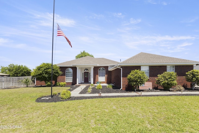 924 N College Blvd, Lynn Haven, FL 32444 - ranch-style home with fence, a front yard, a shingled roof, and brick siding
