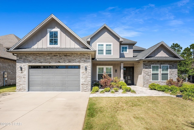 craftsman inspired home featuring a front lawn, driveway, stone siding, and board and batten siding