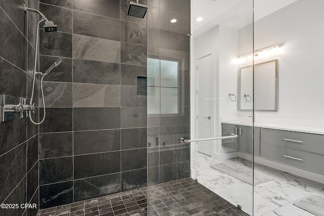 bathroom with walk in shower, recessed lighting, marble finish floor, and vanity