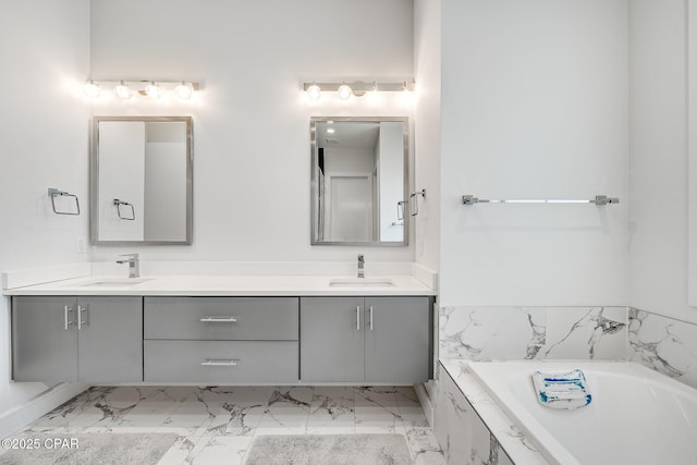 full bath featuring double vanity, marble finish floor, and a sink