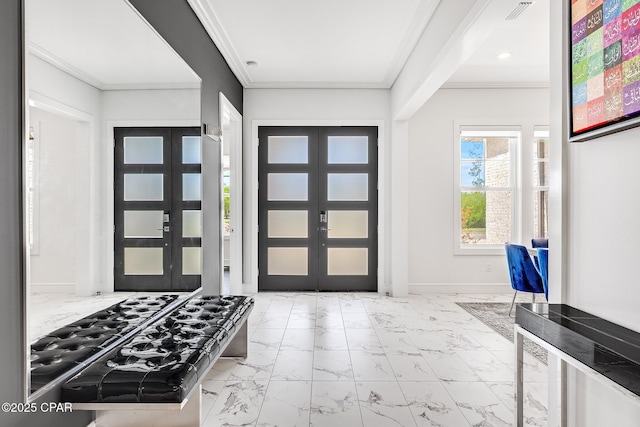 entrance foyer with ornamental molding, marble finish floor, and french doors