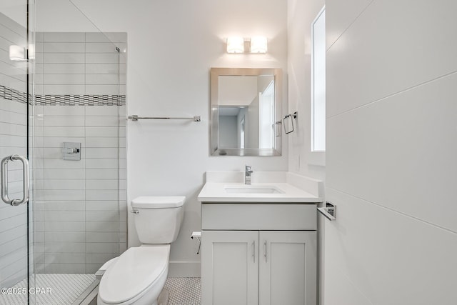 full bathroom with toilet, a stall shower, and vanity