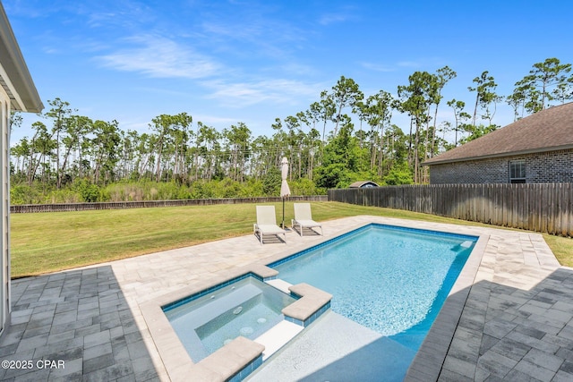 view of swimming pool featuring a patio area, a yard, a pool with connected hot tub, and a fenced backyard