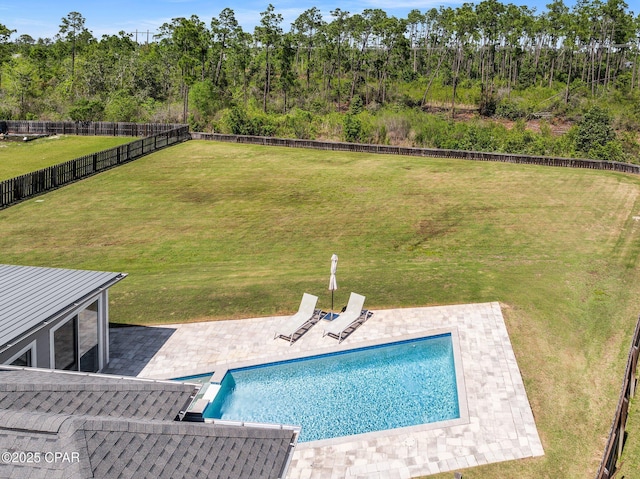 view of swimming pool with a lawn, a fenced in pool, a patio, and a fenced backyard