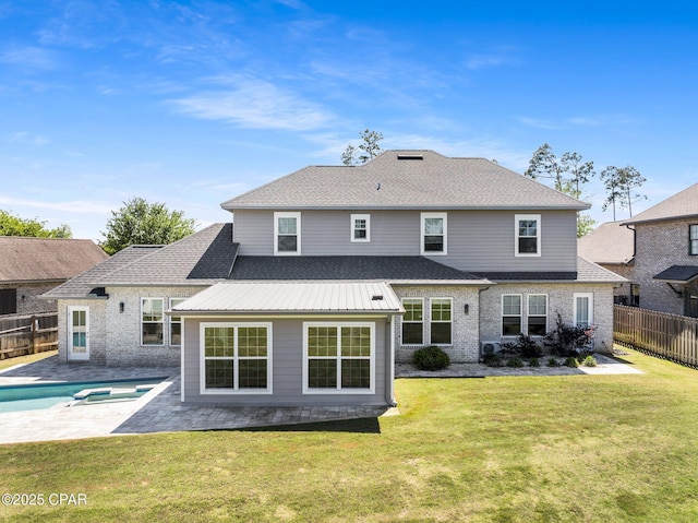 rear view of house featuring a patio, a fenced in pool, a shingled roof, a lawn, and a fenced backyard
