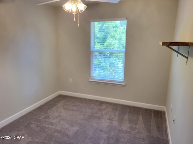 carpeted spare room with baseboards and ceiling fan