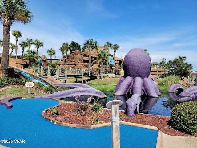 surrounding community featuring a small pond
