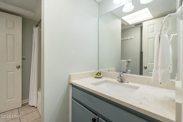 9850 S Thomas Dr Unit 810E, Panama City, FL 32408 - bathroom featuring vanity, tile patterned floors, shower / tub combo, and a drop ceiling