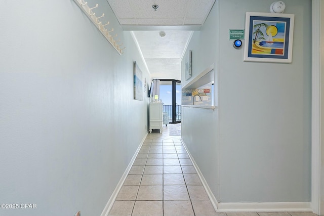 9850 S Thomas Dr Unit 810E, Panama City, FL 32408 - hallway featuring light tile patterned flooring and baseboards