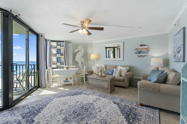 9850 S Thomas Dr Unit 810E, Panama City, FL 32408 - tiled living room with a ceiling fan, a textured ceiling, a water view, and ornamental molding