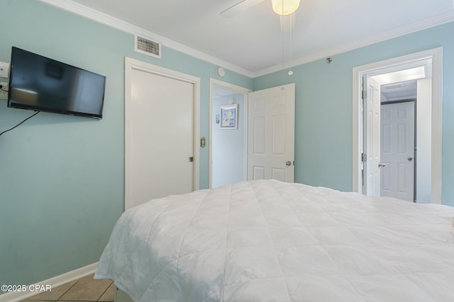 9850 S Thomas Dr Unit 810E, Panama City, FL 32408 - tiled bedroom with ornamental molding, baseboards, and ceiling fan