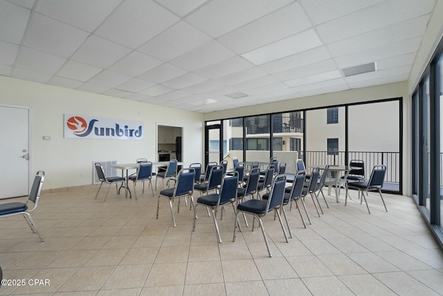 9850 S Thomas Dr Unit 810E, Panama City, FL 32408 - dining area featuring a paneled ceiling and light tile patterned floors