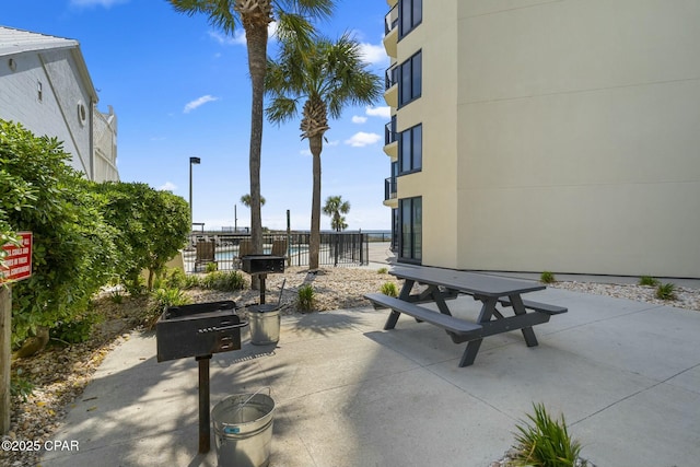 9850 S Thomas Dr Unit 810E, Panama City, FL 32408 - view of community with fence, a patio, and outdoor dining area