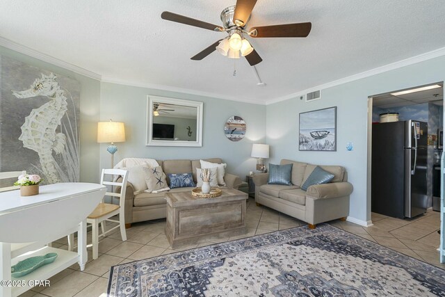 9850 S Thomas Dr Unit 810E, Panama City, FL 32408 - tiled living room with a ceiling fan, ornamental molding, and a textured ceiling