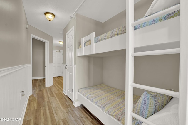 unfurnished bedroom with wood finished floors and a closet