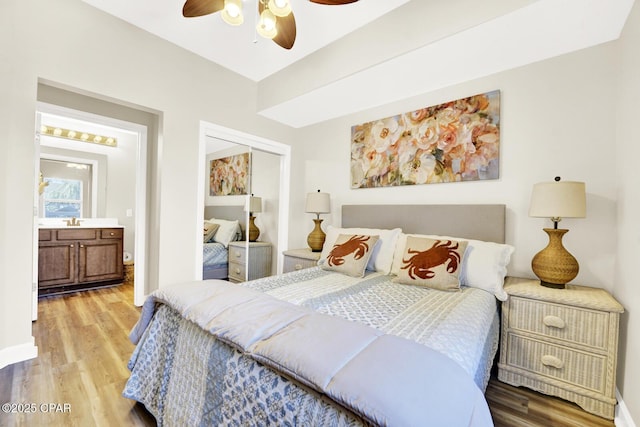 bedroom with light wood-style floors, a closet, a ceiling fan, and baseboards