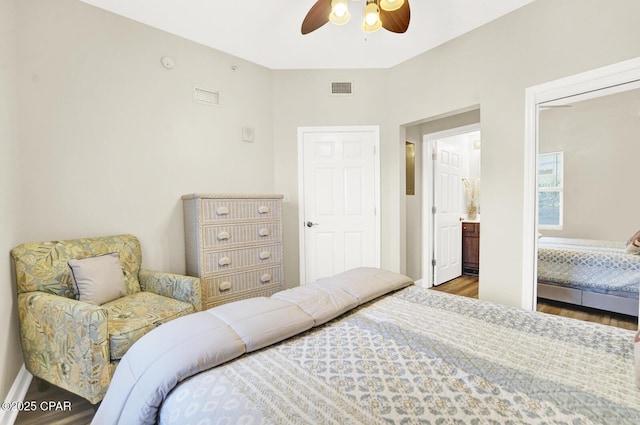 bedroom with wood finished floors, baseboards, and ceiling fan