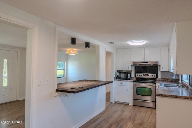 kitchen featuring black microwave, light wood-style flooring, electric stove, white cabinetry, and under cabinet range hood