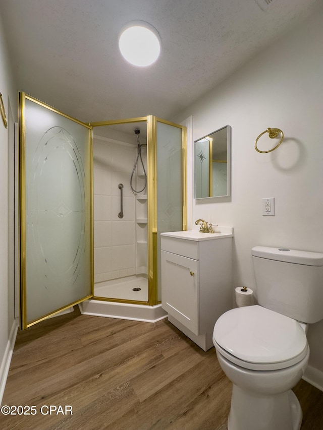 full bathroom featuring vanity, wood finished floors, and a shower stall