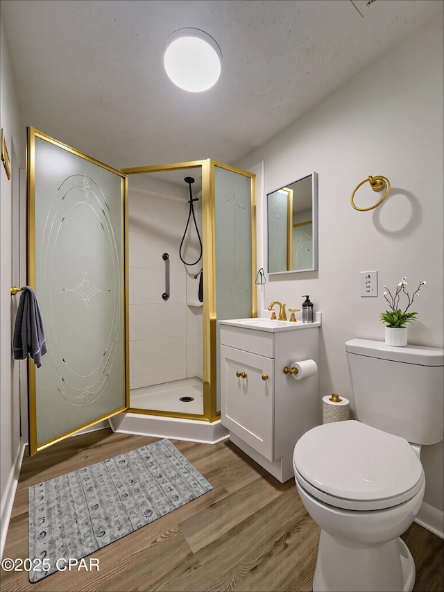 7851 Jenkins St, Sneads, FL 32460 - full bathroom with toilet, a shower stall, wood finished floors, and vanity