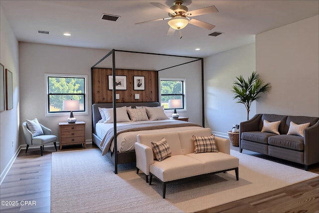 bedroom with visible vents, a ceiling fan, and light wood finished floors