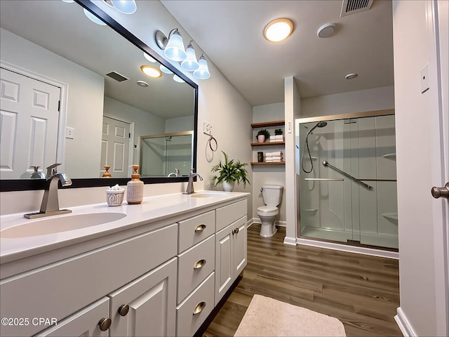 7851 Jenkins St, Sneads, FL 32460 - full bathroom featuring visible vents, a shower stall, a sink, and wood finished floors